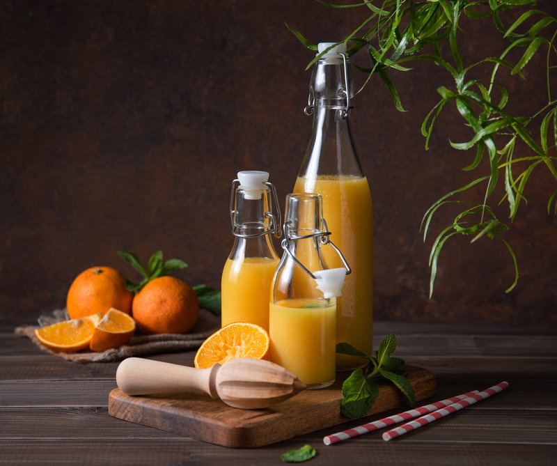 orange-juice-in-glass-bottles-with-fruit-2026-03-16-00-34-28-utc